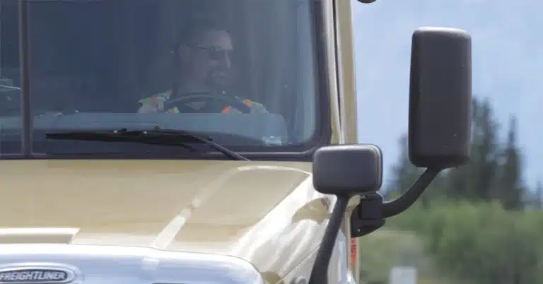 Bison Driver looking out of the window of a highway tractor door
